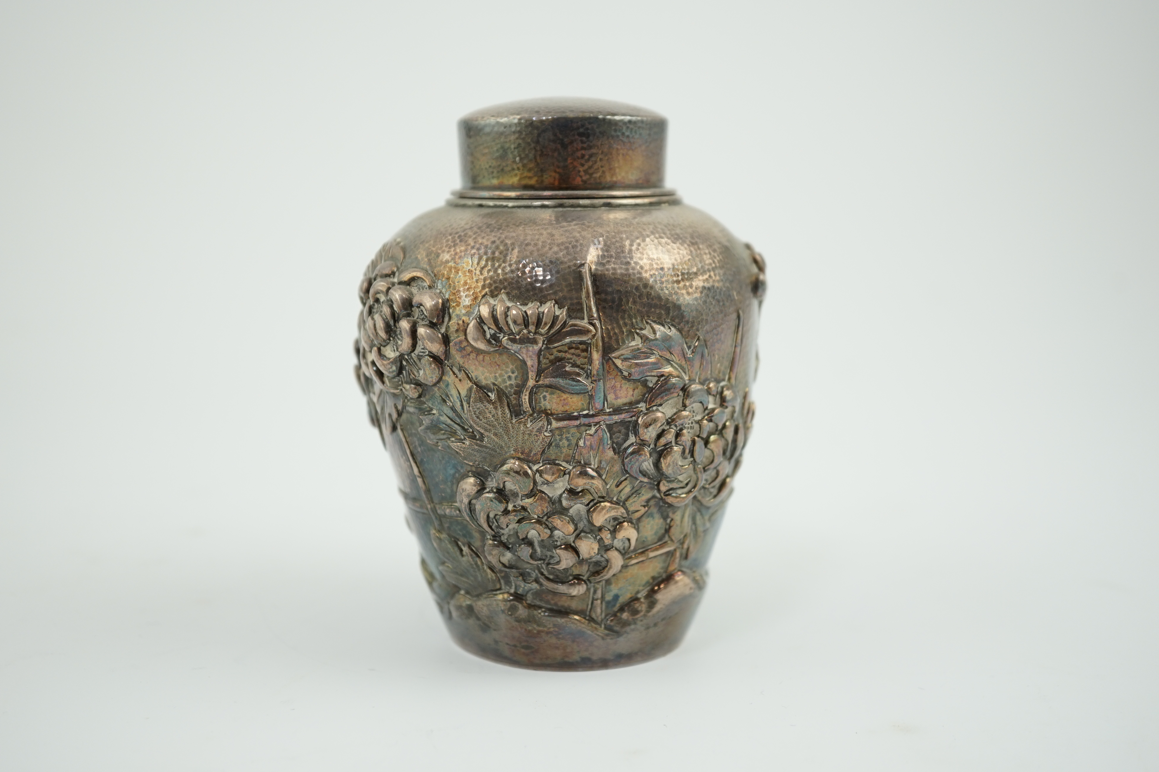 An early 20th century Japanese silver ovoid tea caddy and cover, decorated with prunus, together with a similar Japanese silver bowl